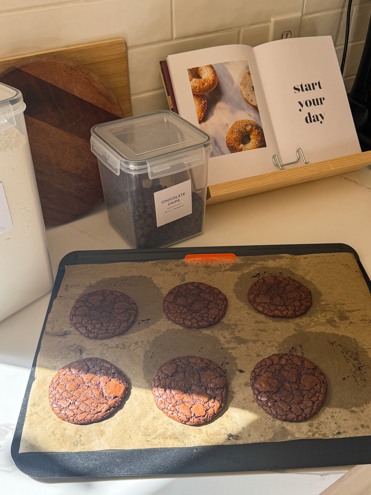 Chocolate Mocha Brownie Cookies - on a tray, in front of my cookbook and a container of chocolate chips