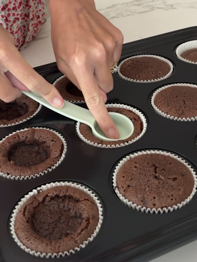 Pressing indents into the brownie cups using a tablespoon measure