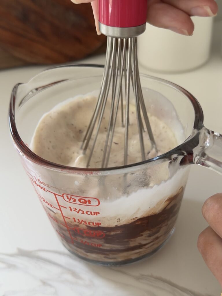 Whisking the cream and chocolate to make the ganache
