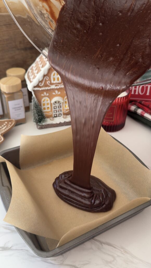 Pouring brownie batter into prepared pan (image 1/3)
